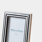 https://s3-ap-southeast-2.amazonaws.com/fusionfactory.commerceconnect.bbnt.production/pim_media/000/210/035/M_F_W26_Horgan-Resin-Frame-4x6_Navy-White_26906101_Detail_SI.jpg?1771221155